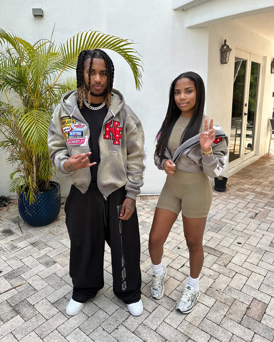 two customers outside, both wearing the ash k1 zip up