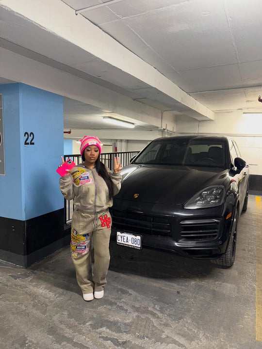 customer in the full ash k1 tracksuit and a pink beanie in a parking garage